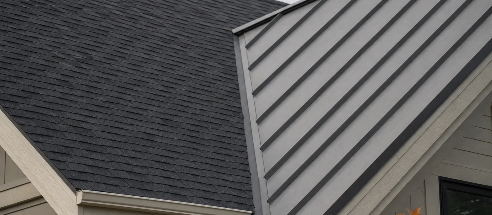 Asphalt shingles and standing-seam metal on adjacent roof planes