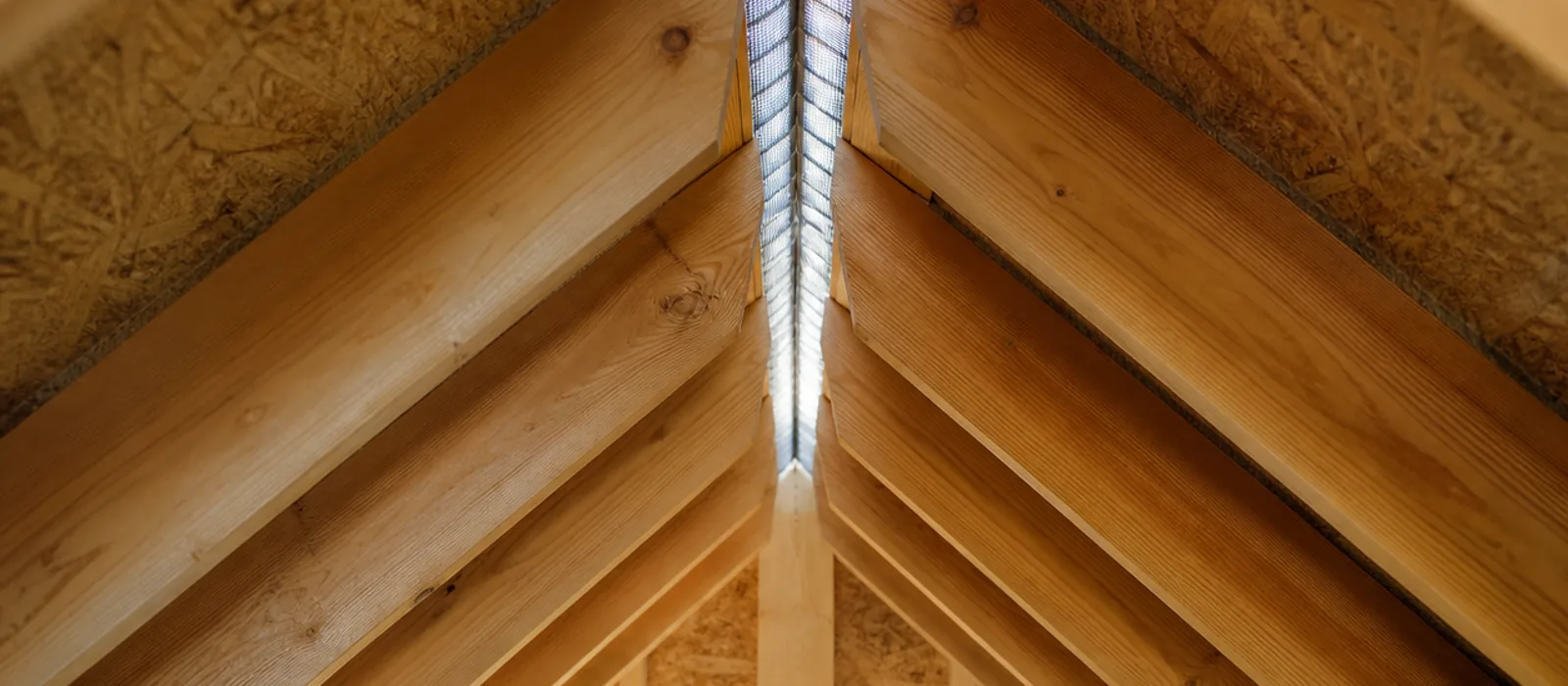 Attic rafters converging at a continuous ridge vent