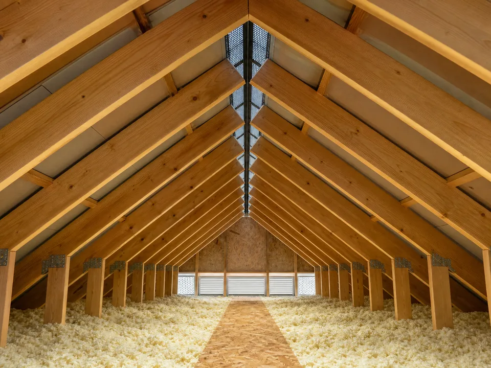 Attic rafters converging at a continuous ridge vent
