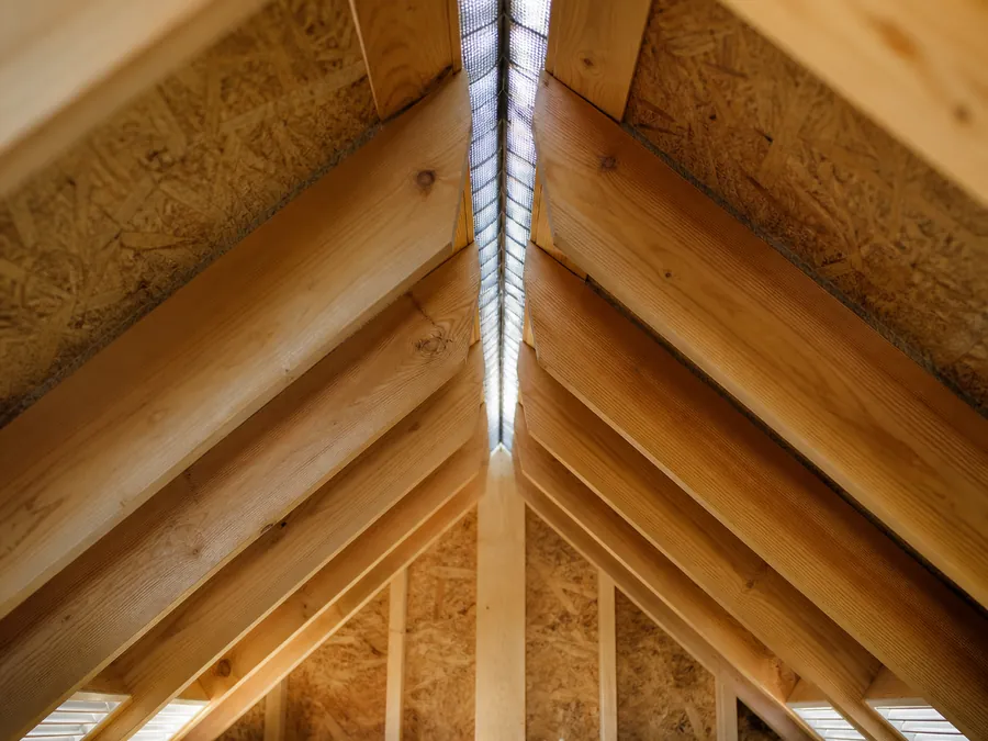 Attic rafters converging at a continuous ridge vent